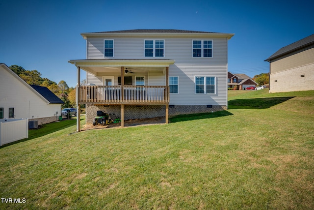 back of property featuring ceiling fan, a lawn, and central AC unit