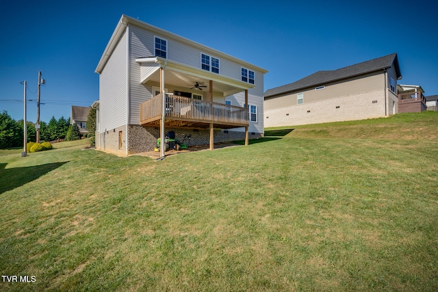 back of house with a deck, a yard, and ceiling fan