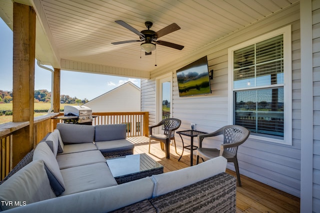 deck featuring outdoor lounge area, a grill, and ceiling fan