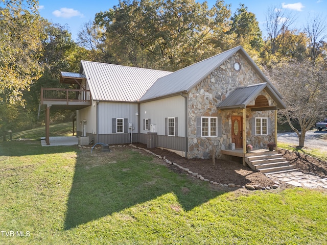 view of front facade with a balcony and a front lawn