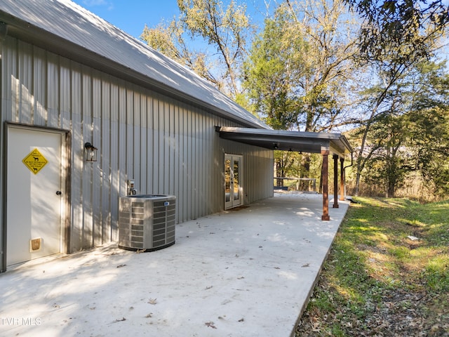 view of property exterior with central AC and a carport