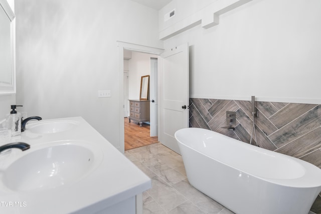 bathroom featuring vanity and a tub