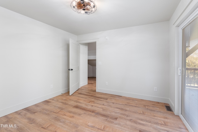 empty room with light hardwood / wood-style flooring