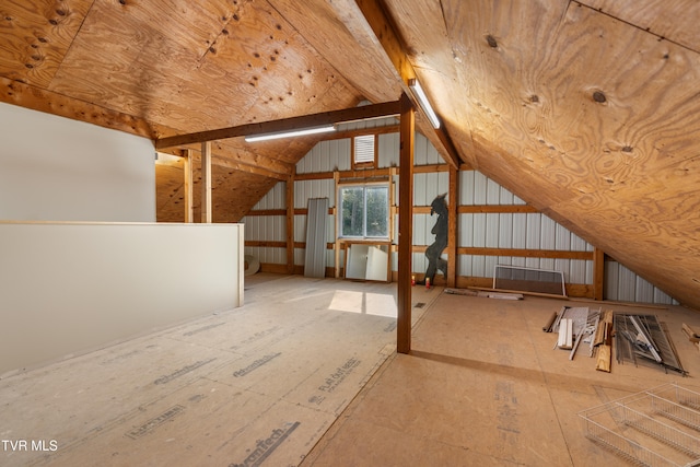 bonus room with lofted ceiling with beams