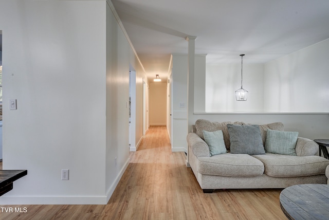 living room featuring an inviting chandelier and light wood-type flooring