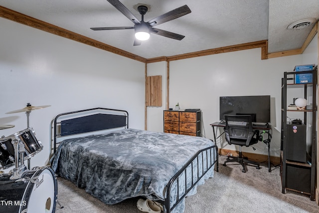 bedroom with ceiling fan, crown molding, a textured ceiling, and carpet