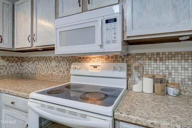 kitchen featuring tasteful backsplash and white appliances