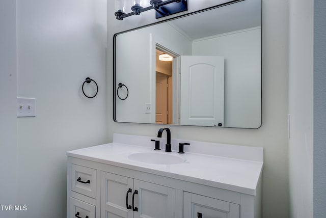 bathroom with ornamental molding and vanity