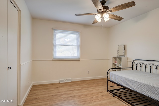 bedroom with ceiling fan and light hardwood / wood-style floors