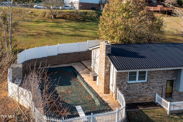 view of pool featuring a patio and a lawn