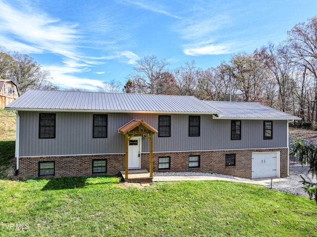 raised ranch with a garage and a front lawn