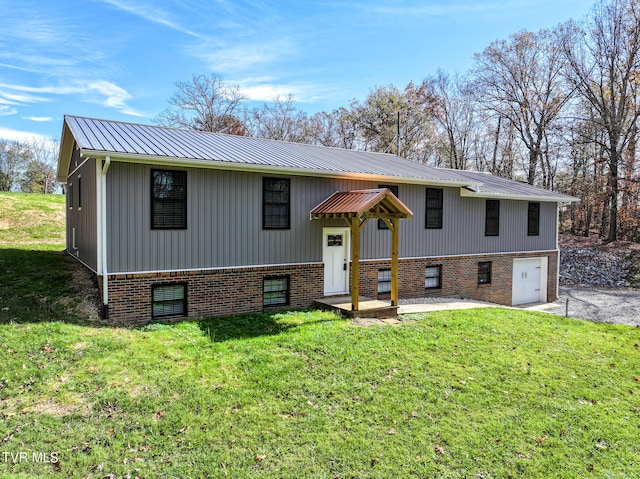 bi-level home with a front lawn and a garage