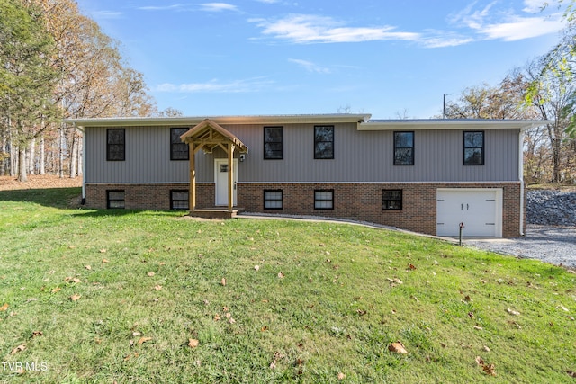 split foyer home with a front yard and a garage