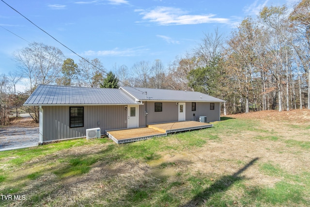 rear view of property featuring central AC and a deck