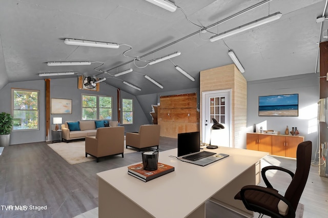 home office featuring vaulted ceiling and light wood-style floors