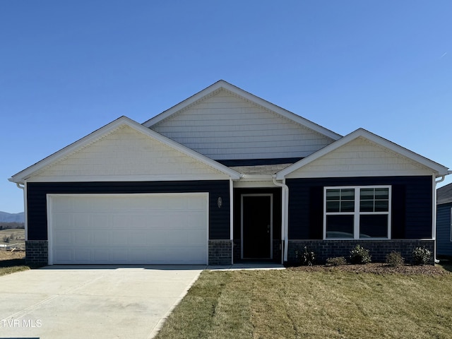 view of front of house with a front yard, an attached garage, and driveway