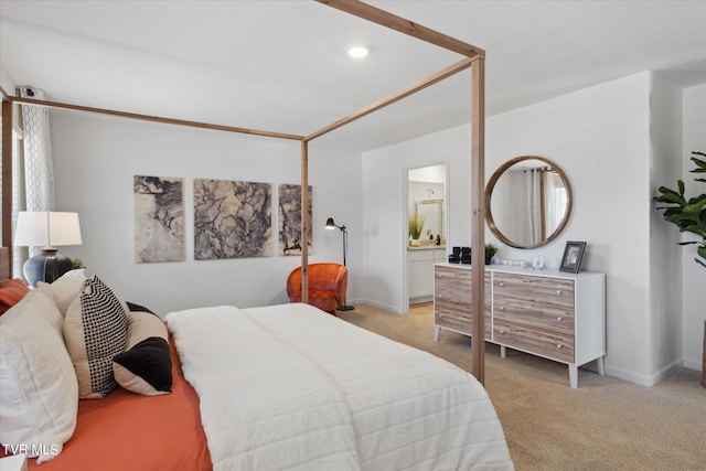 carpeted bedroom featuring connected bathroom