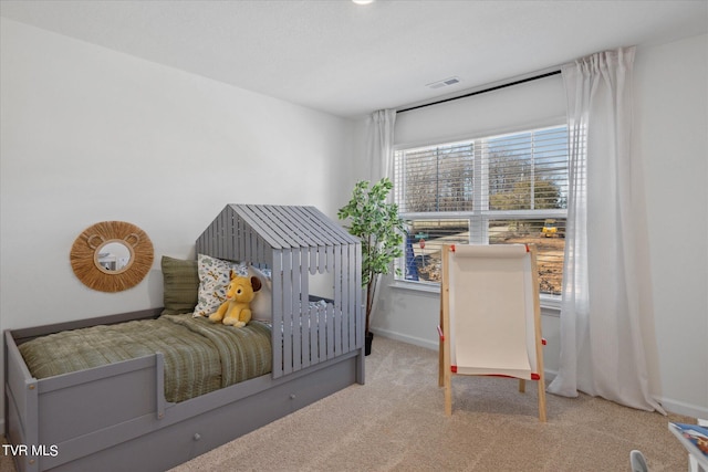 carpeted bedroom featuring multiple windows