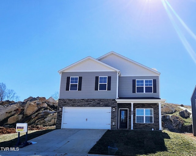 traditional home featuring an attached garage, concrete driveway, and stone siding