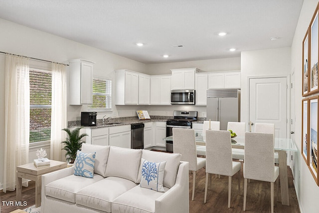 kitchen featuring white cabinetry, appliances with stainless steel finishes, and a sink