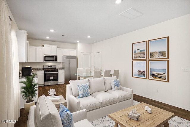 living room with dark wood-style floors, baseboards, and recessed lighting