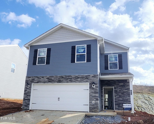 view of front of house with a garage and stone siding