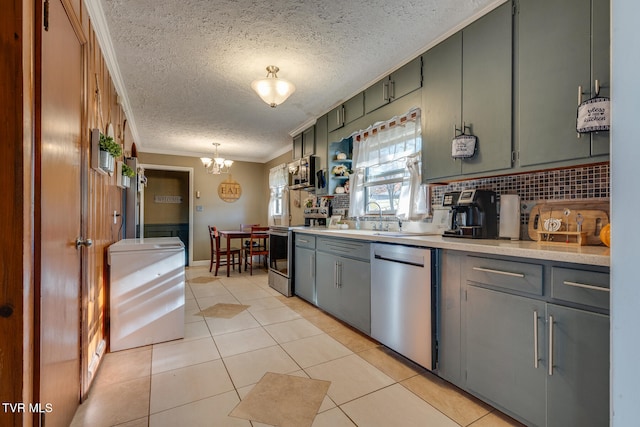 kitchen featuring hanging light fixtures, backsplash, appliances with stainless steel finishes, light tile patterned flooring, and crown molding