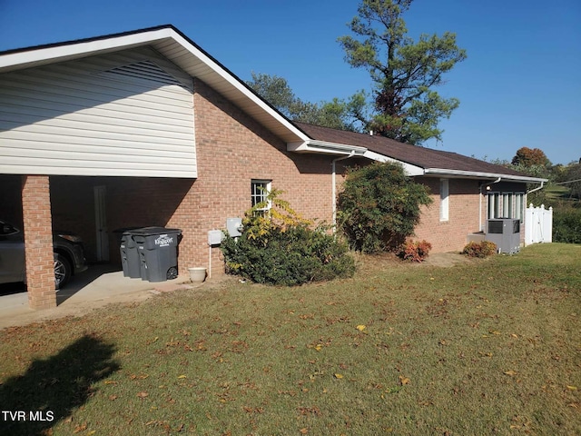 view of side of home featuring a yard and cooling unit