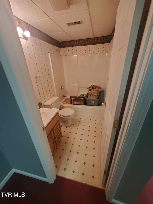 full bathroom with toilet, a paneled ceiling, vanity, and independent shower and bath