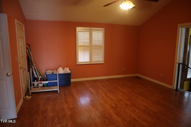 unfurnished room with lofted ceiling, ceiling fan, and dark hardwood / wood-style flooring