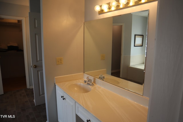 bathroom featuring vanity and a tub to relax in