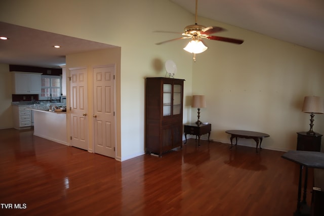 interior space featuring dark hardwood / wood-style floors, ceiling fan, and vaulted ceiling