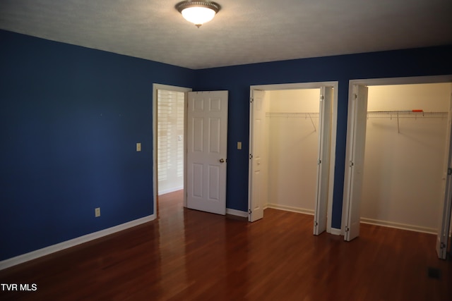 unfurnished bedroom with dark hardwood / wood-style floors