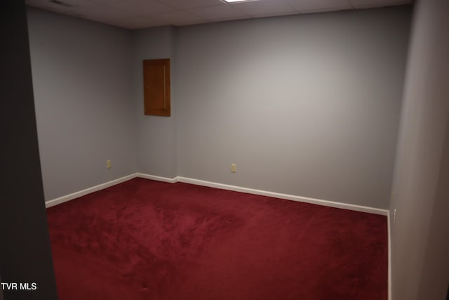 unfurnished room with a drop ceiling and carpet flooring