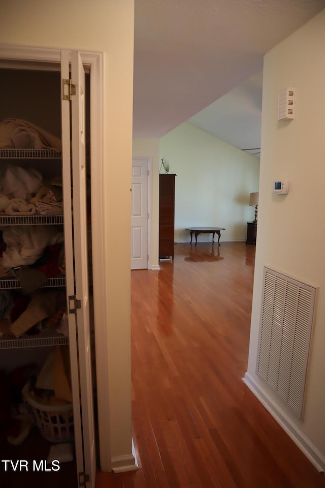 hall with hardwood / wood-style floors