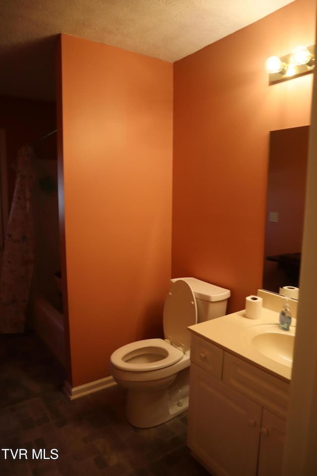 full bathroom with a textured ceiling, wood-type flooring, toilet, shower / bath combo, and vanity