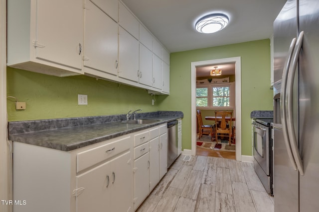 kitchen featuring white cabinetry, light hardwood / wood-style floors, stainless steel appliances, and sink