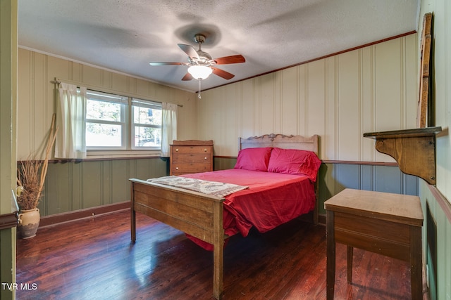 bedroom with a textured ceiling, dark hardwood / wood-style floors, and ceiling fan