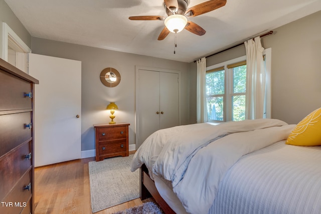 bedroom featuring light hardwood / wood-style flooring, a closet, and ceiling fan
