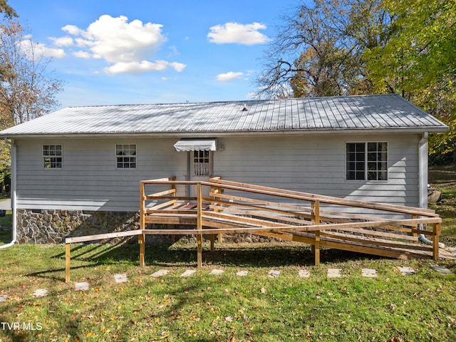 rear view of property with a yard