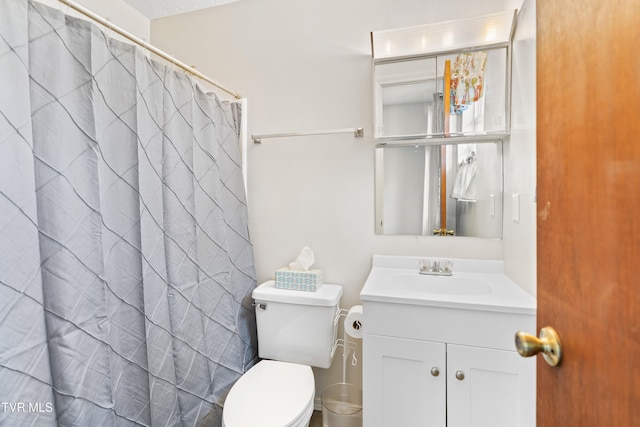 bathroom featuring vanity, toilet, and a shower with shower curtain