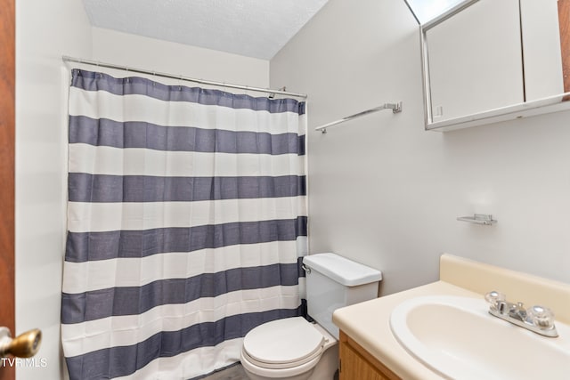 bathroom featuring vanity, walk in shower, a textured ceiling, and toilet