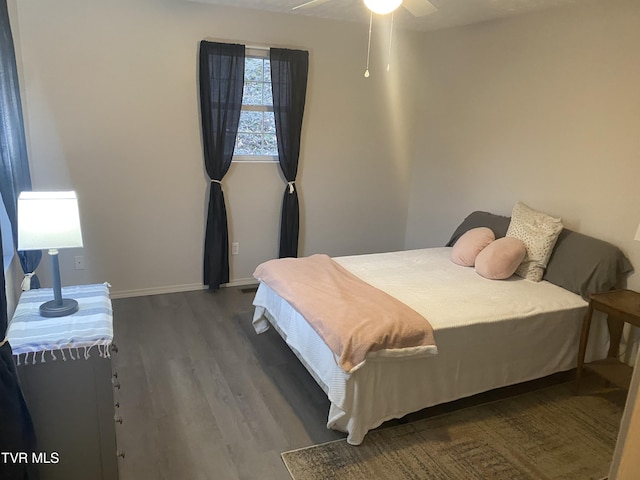 bedroom with dark wood-type flooring and ceiling fan