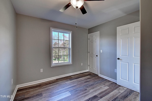 spare room with ceiling fan and wood-type flooring