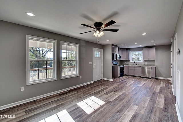 kitchen featuring gray cabinetry, plenty of natural light, light wood-type flooring, and appliances with stainless steel finishes