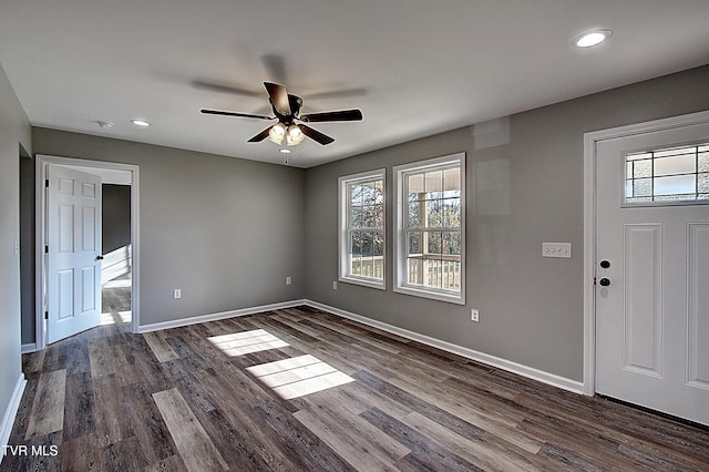 foyer with ceiling fan, plenty of natural light, and dark hardwood / wood-style floors