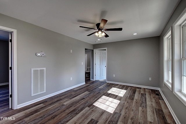 unfurnished bedroom featuring ceiling fan and dark hardwood / wood-style floors