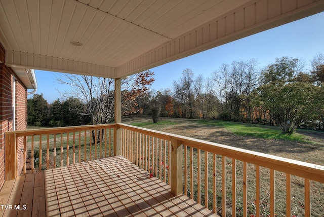 wooden deck with a lawn