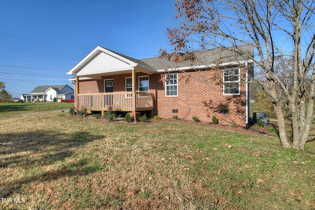 exterior space with cooling unit and a yard