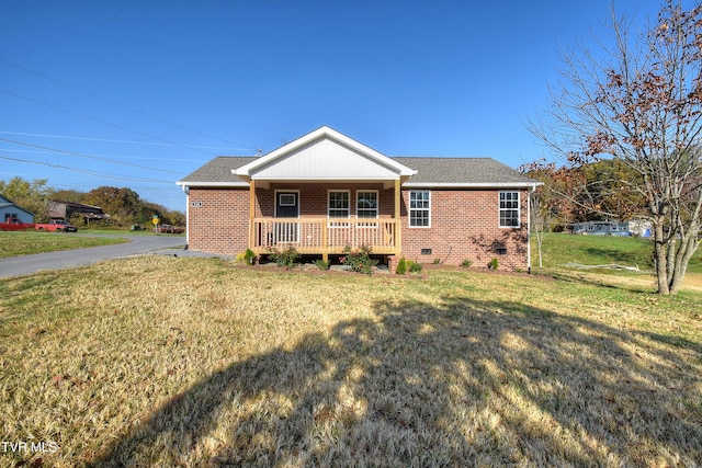 rear view of property featuring covered porch and a yard